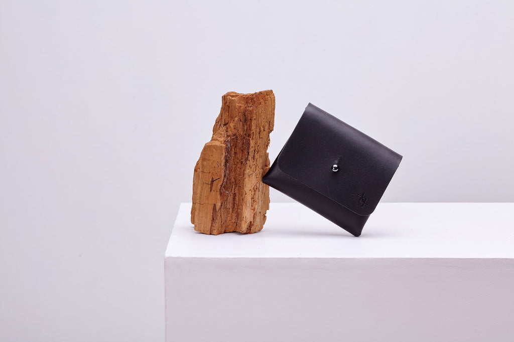 functional minimalist deep pouchie wallet with detachable strap on a clean background