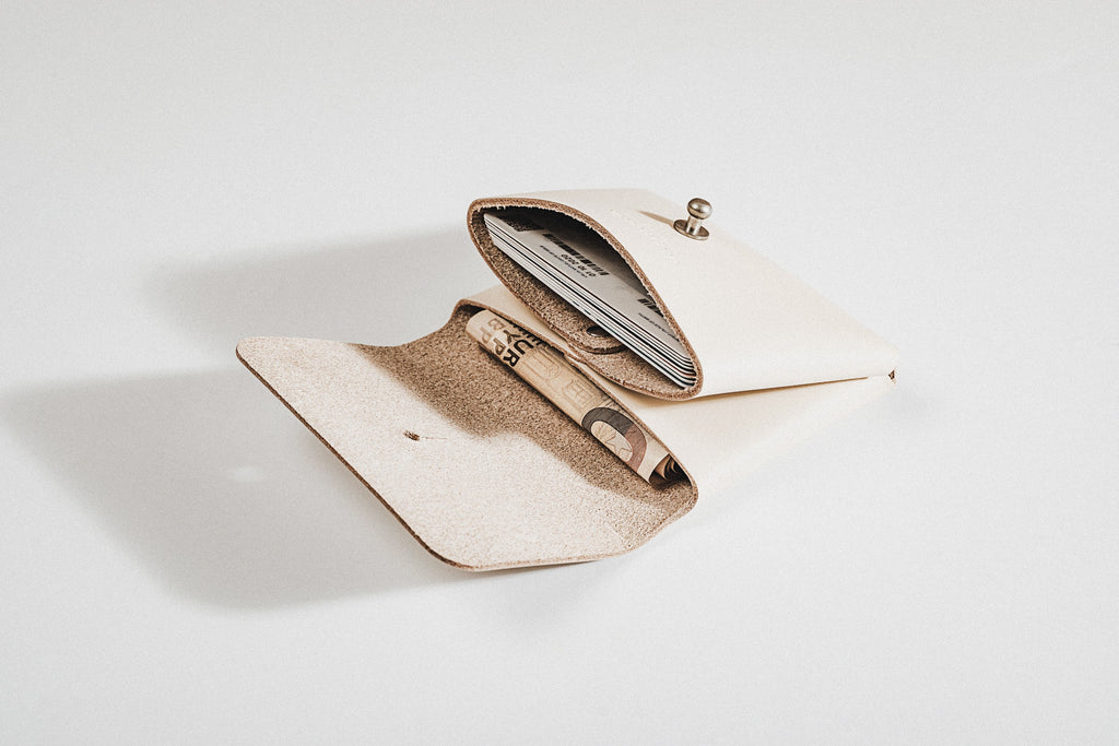 close-up of the deep pouchie wallet's vegetable-tanned leather texture and dual compartments