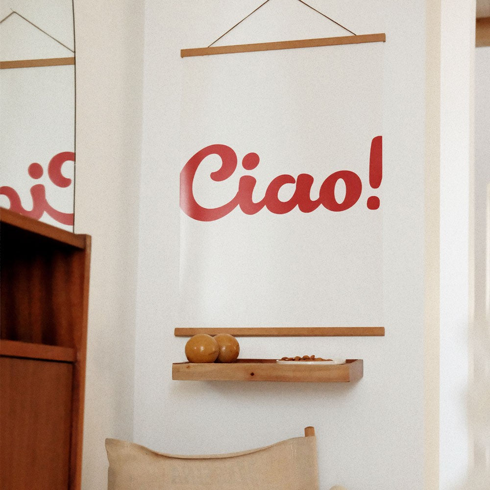 playful ciao poster on a sunlit wall in a bright kitchen with herbs