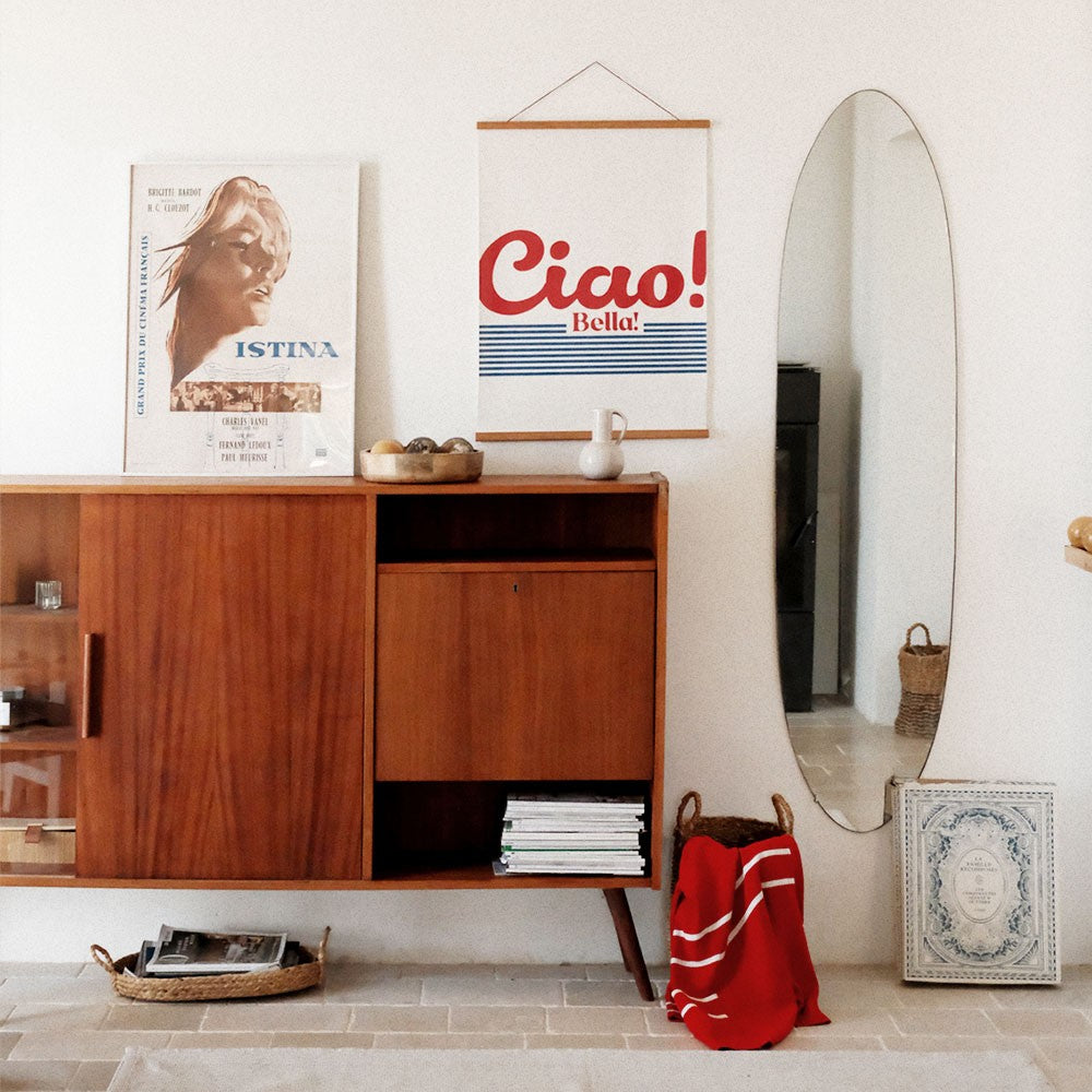 elegant ciao bella poster in soft morning light on a minimalist shelf