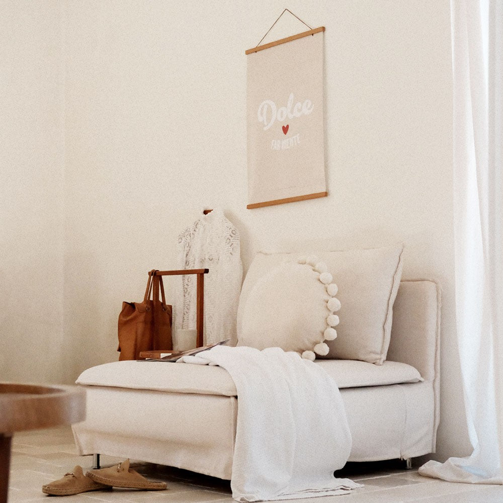softly lit dolce far niente poster on a cozy bedroom wall with warm morning light