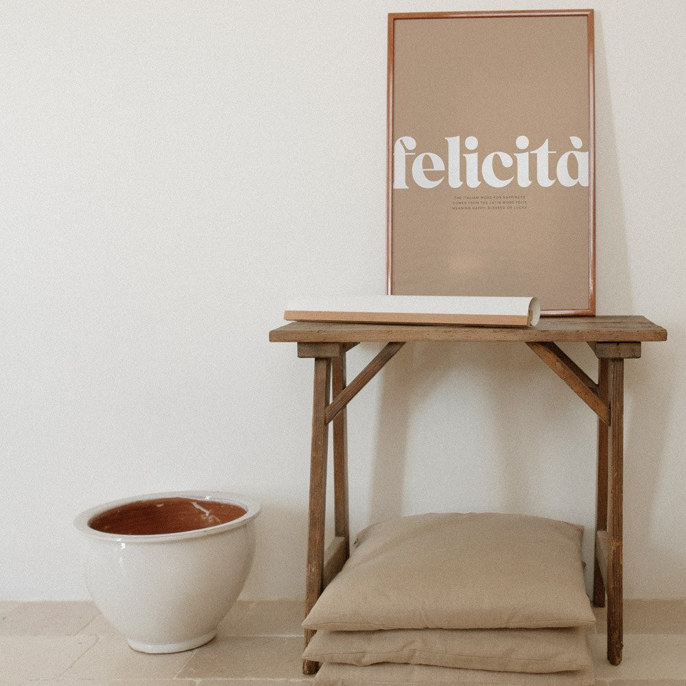 softly lit minimalist felicita poster with gentle italian typography on a cozy wall