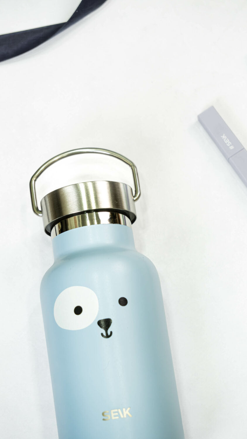 elegant blue puppy thermos on a marble surface, showcasing its refined stainless steel design
