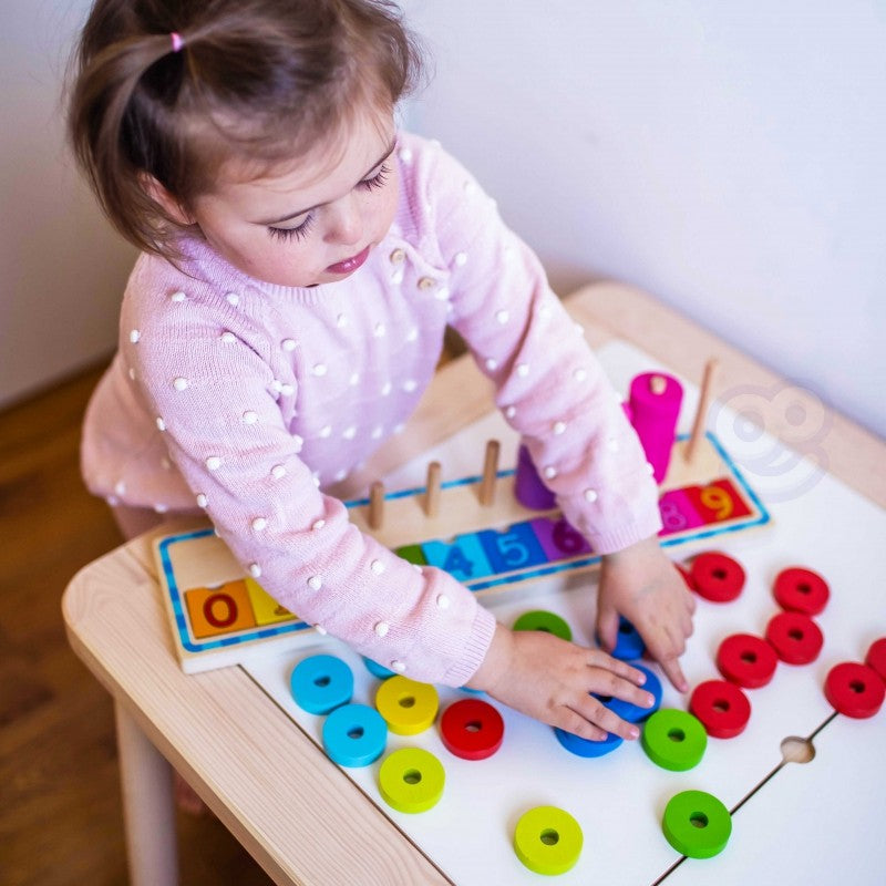 confident toddler mastering the wooden color and counting puzzle on a bright play mat