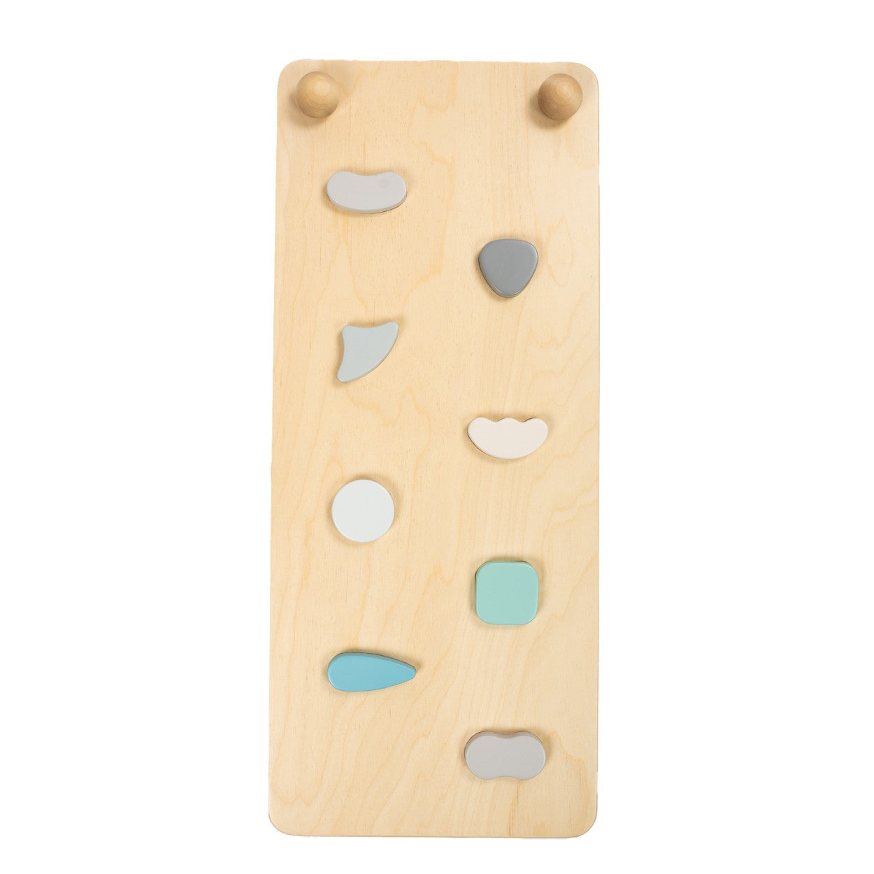 close-up detail of the textured rock holds on the pastel climbing ramp