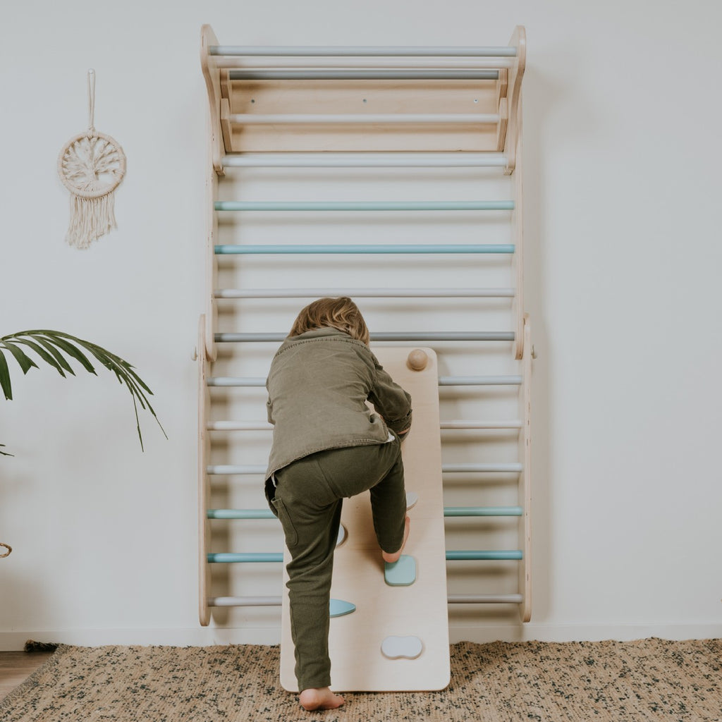a bold toddler confidently climbing the pastel ramp in dramatic morning light