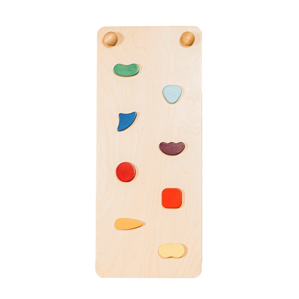 a soft-lit rainbow climbing ramp with gentle scandinavian hues, resting on a cozy nursery rug