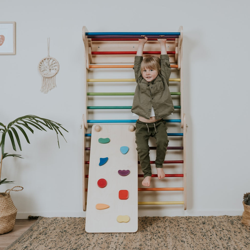 an elegant birch plywood rainbow ramp with subtle scandinavian hues and tactile rock holds