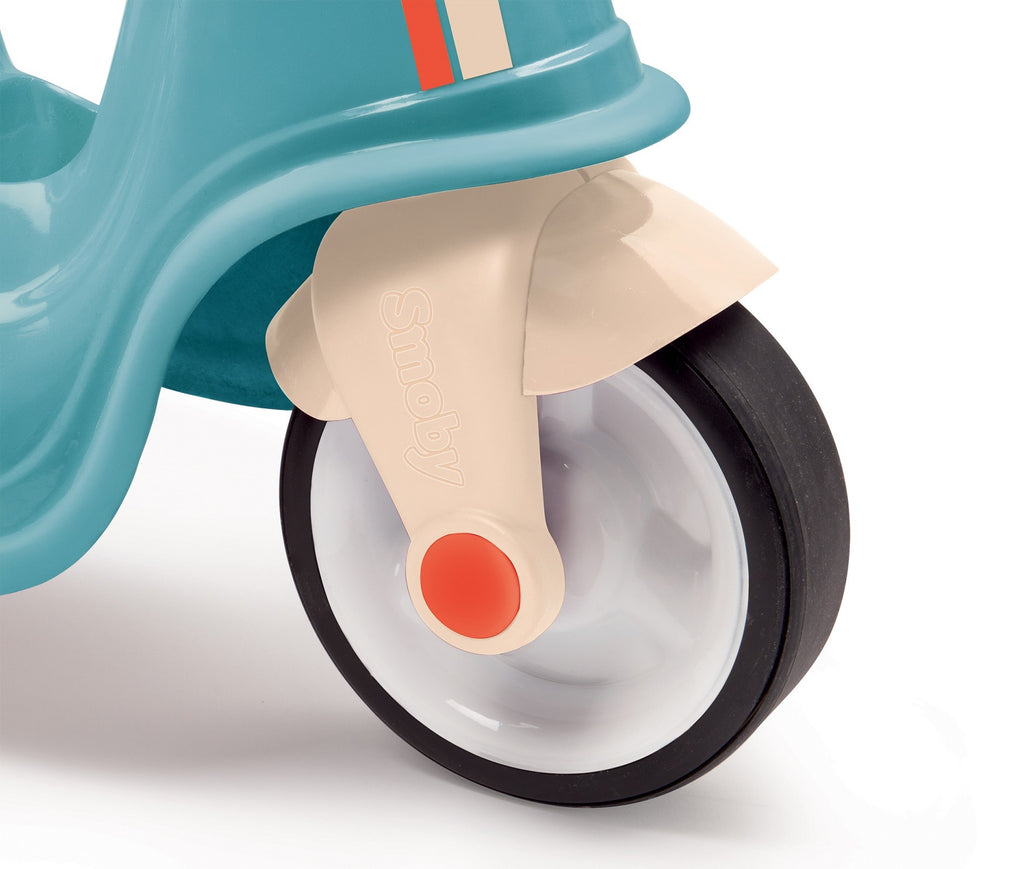 elegant french-made blue retro scooter for toddlers, showcasing its refined profile and plush seat in soft morning light