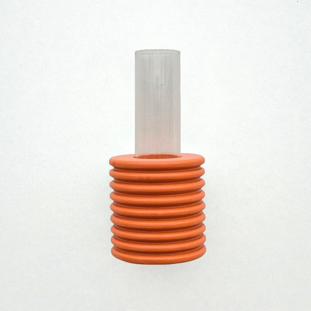 close-up of orange ribble wall vase with metal hook for easy mounting on beige wall