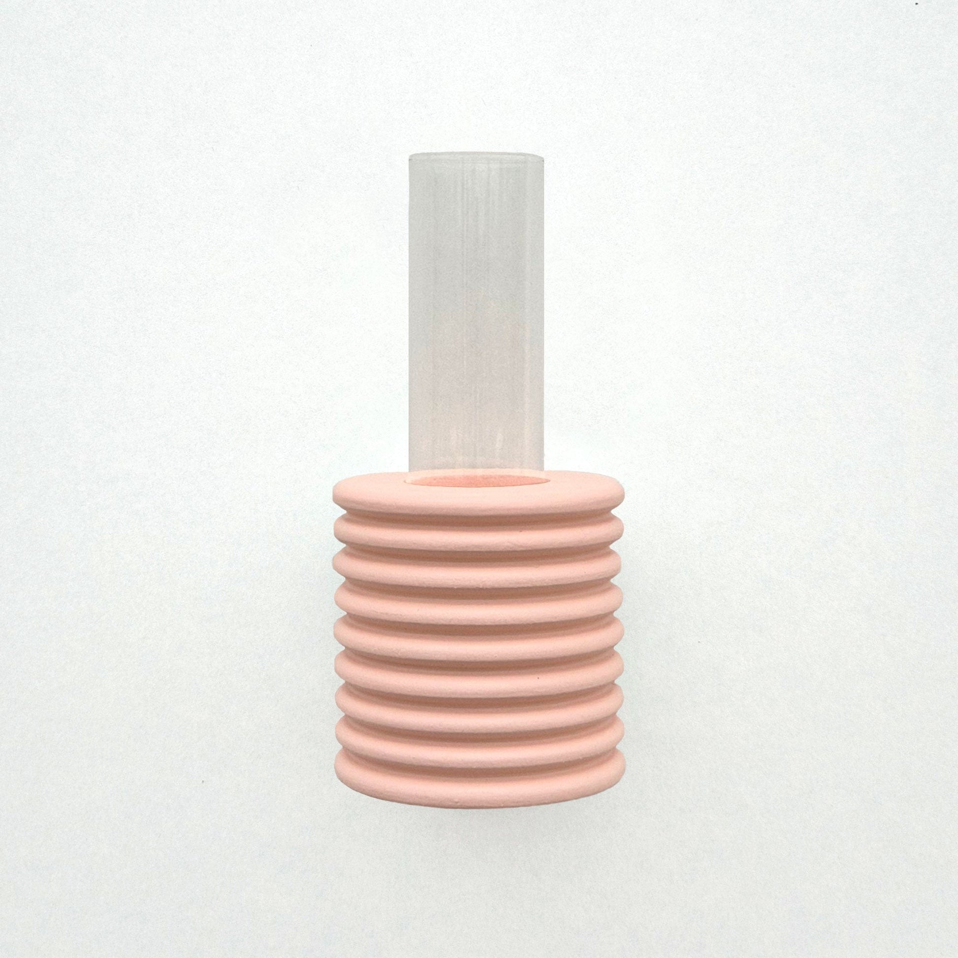 elegant pink ribble wall vase with a single dried flower against a minimalist backdrop