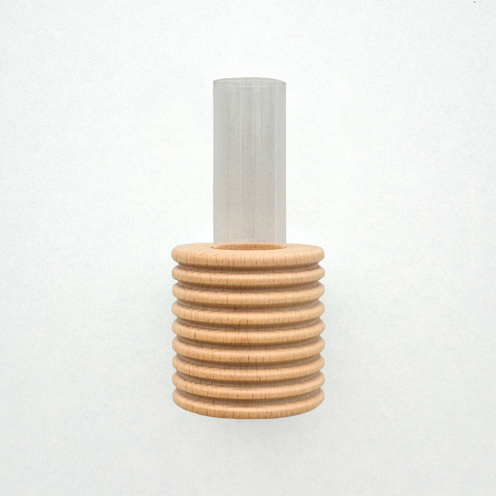 playful blue beech wood wall vase with a single bright yellow flower on a sunny kitchen wall