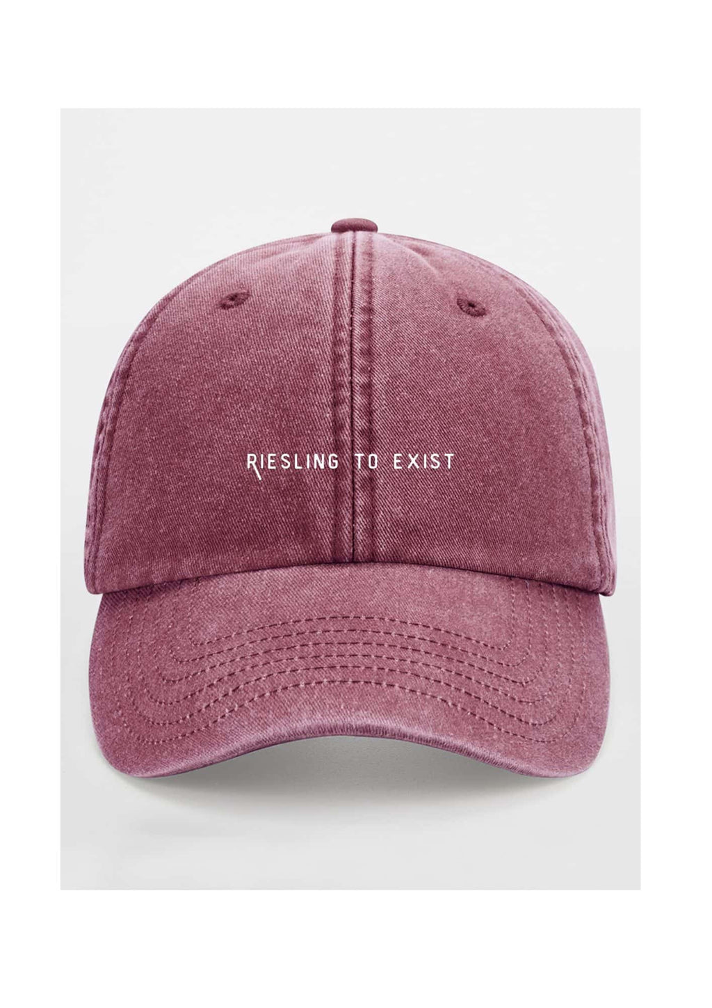 a soft cotton cap with the riesling to exist slogan in warm, gentle light