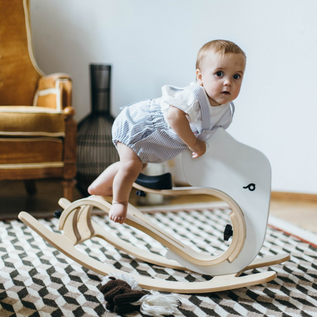 a close-up detail shot of the rocking elephant add-on's sturdy wooden connection point