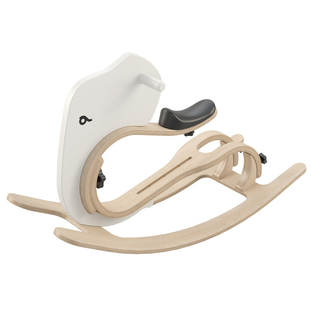 a contemporary wooden rocking elephant add-on for a balance bike, shown in warm morning light