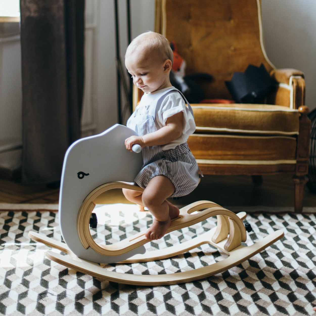 a bold low-angle shot of the rocking elephant add-on attached to its balance bike