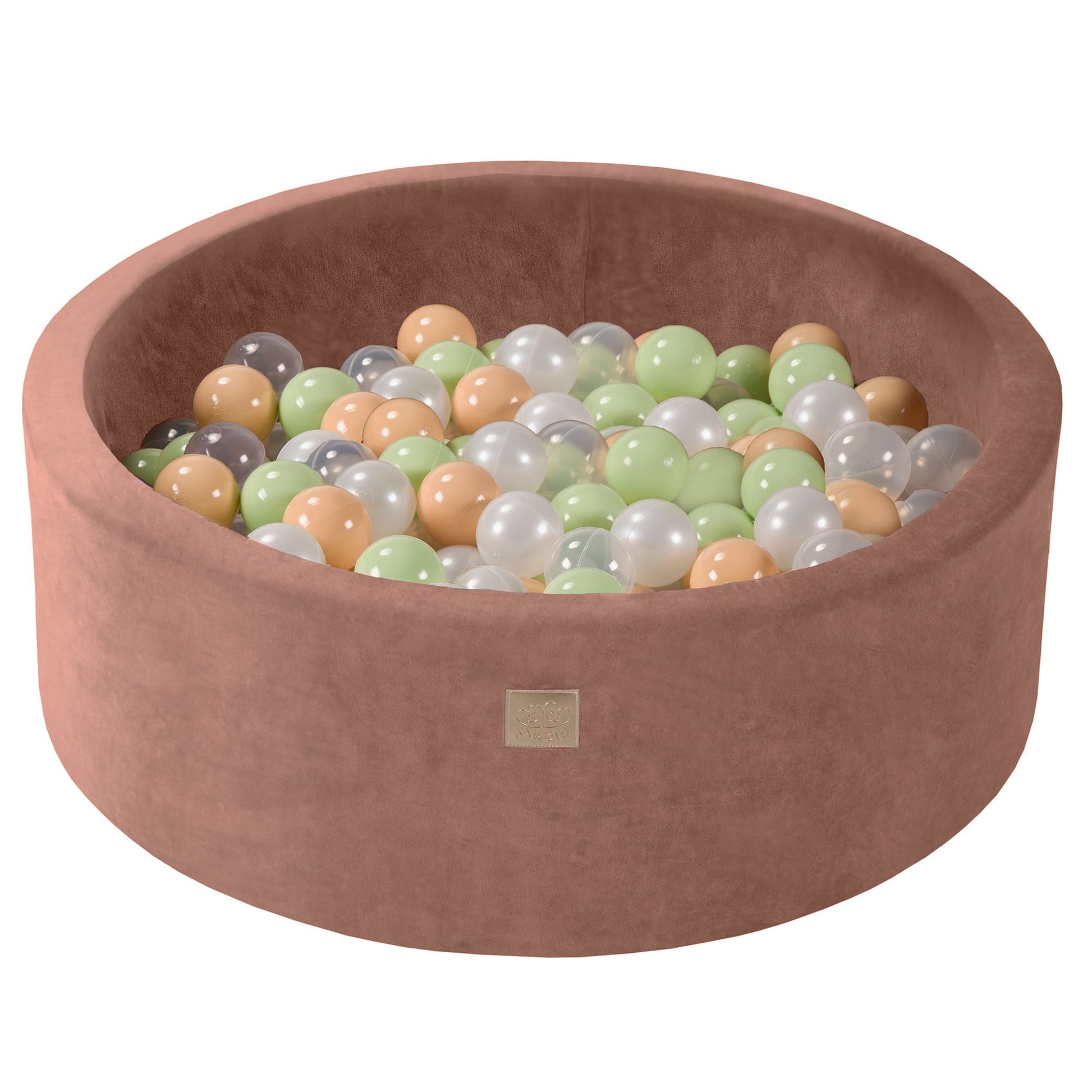 a bold statement piece - a beige velvet ball pit overflowing with 200 soft sensory balls in a modern living room