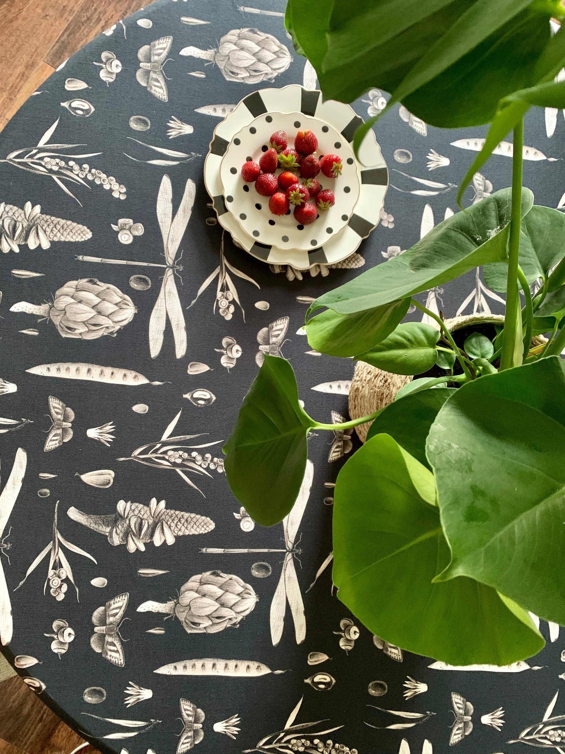 a close-up detail of the seeds carbon print on a round cotton tablecloth, showcasing its artisan texture