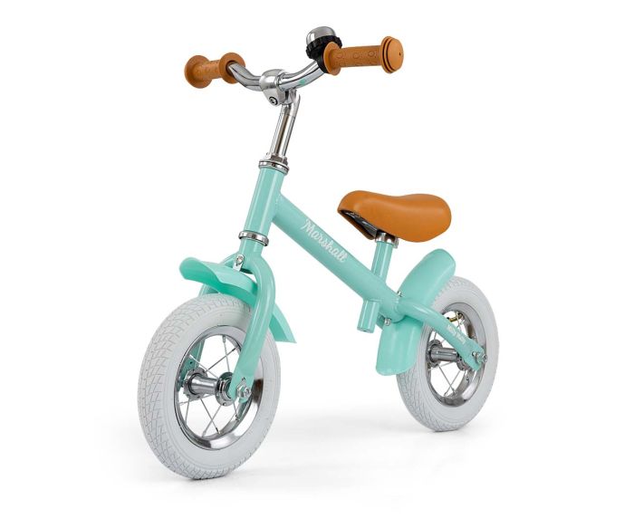 a child's marshall balance bike on a sun-drenched garden path, ready for a new adventure