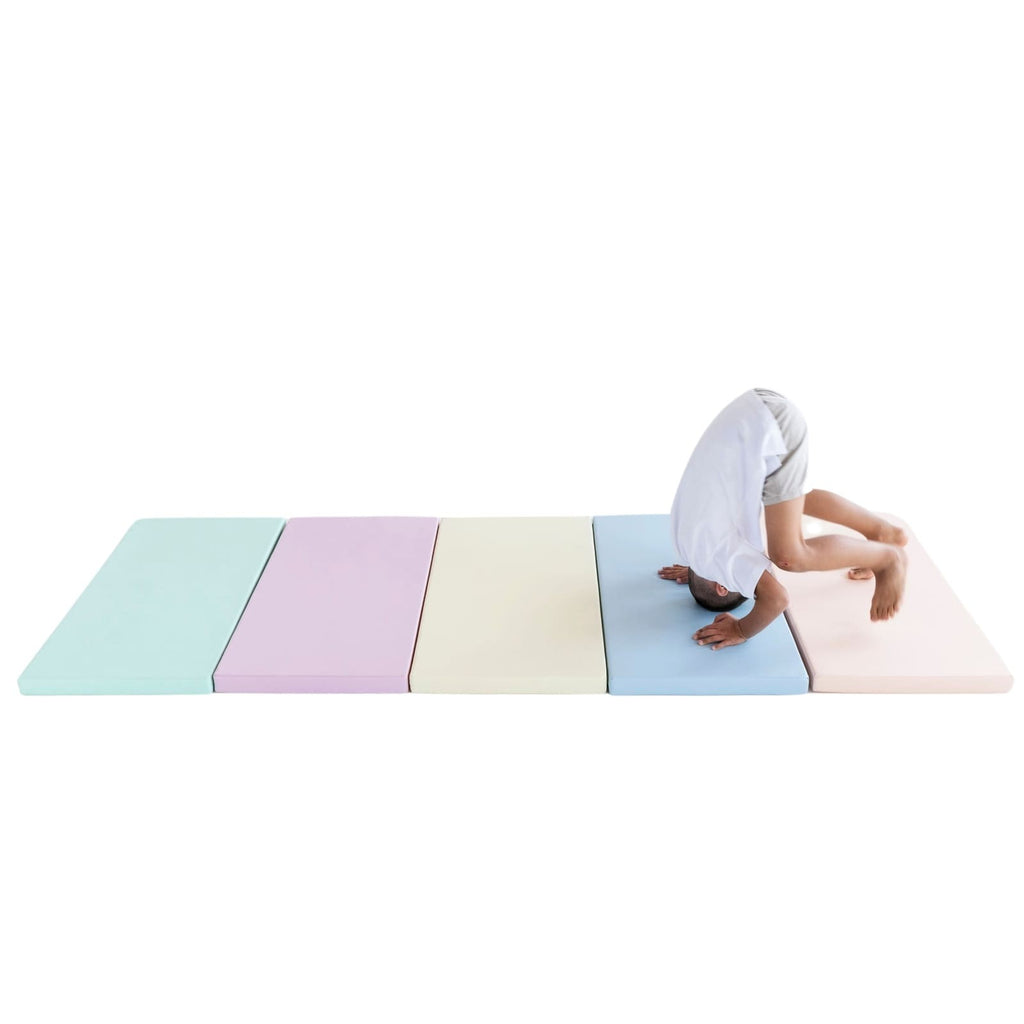 soft pastel play mat set arranged in a nursery corner with soft morning light