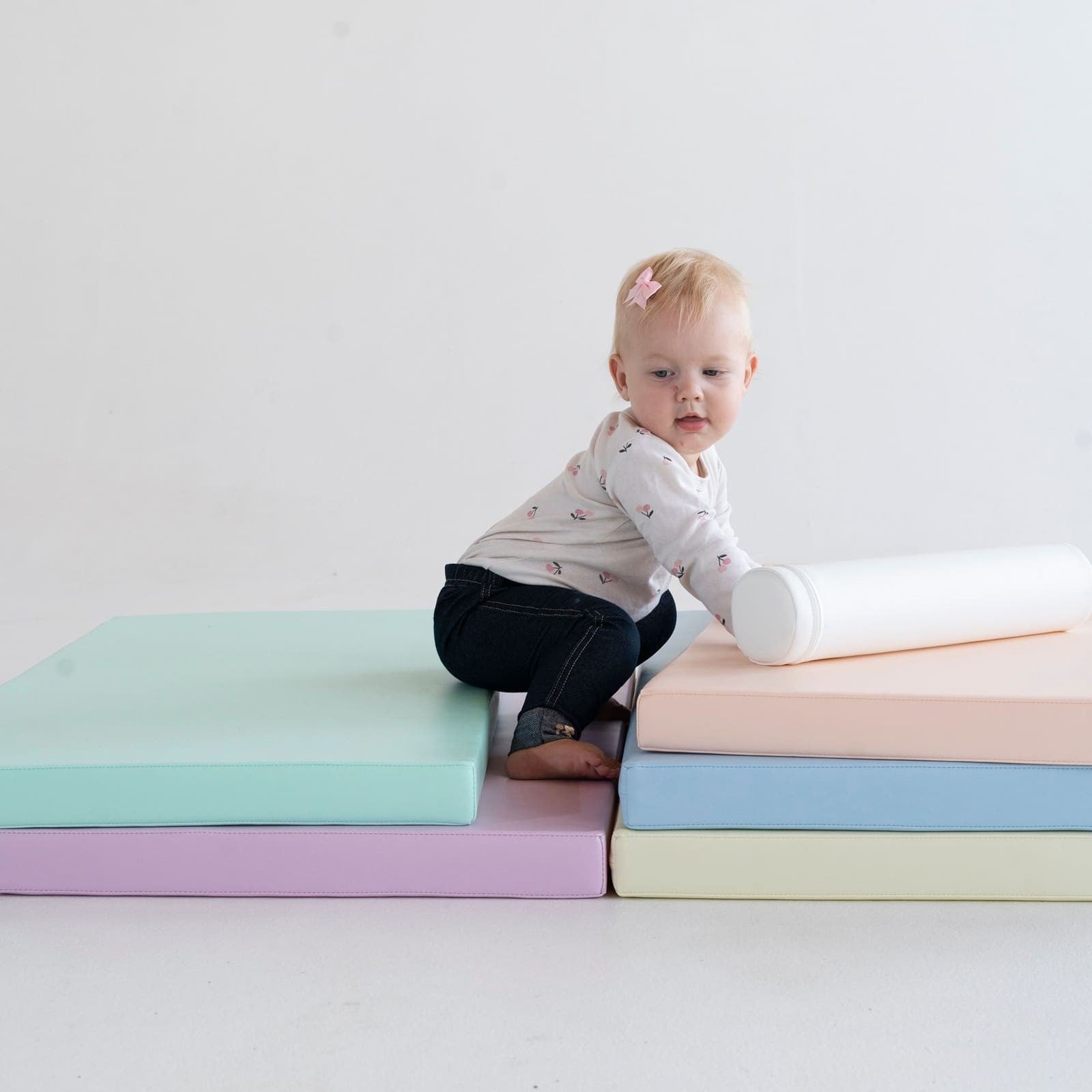 soft pastel iglu play mat set arranged in a playful pattern on a nursery floor