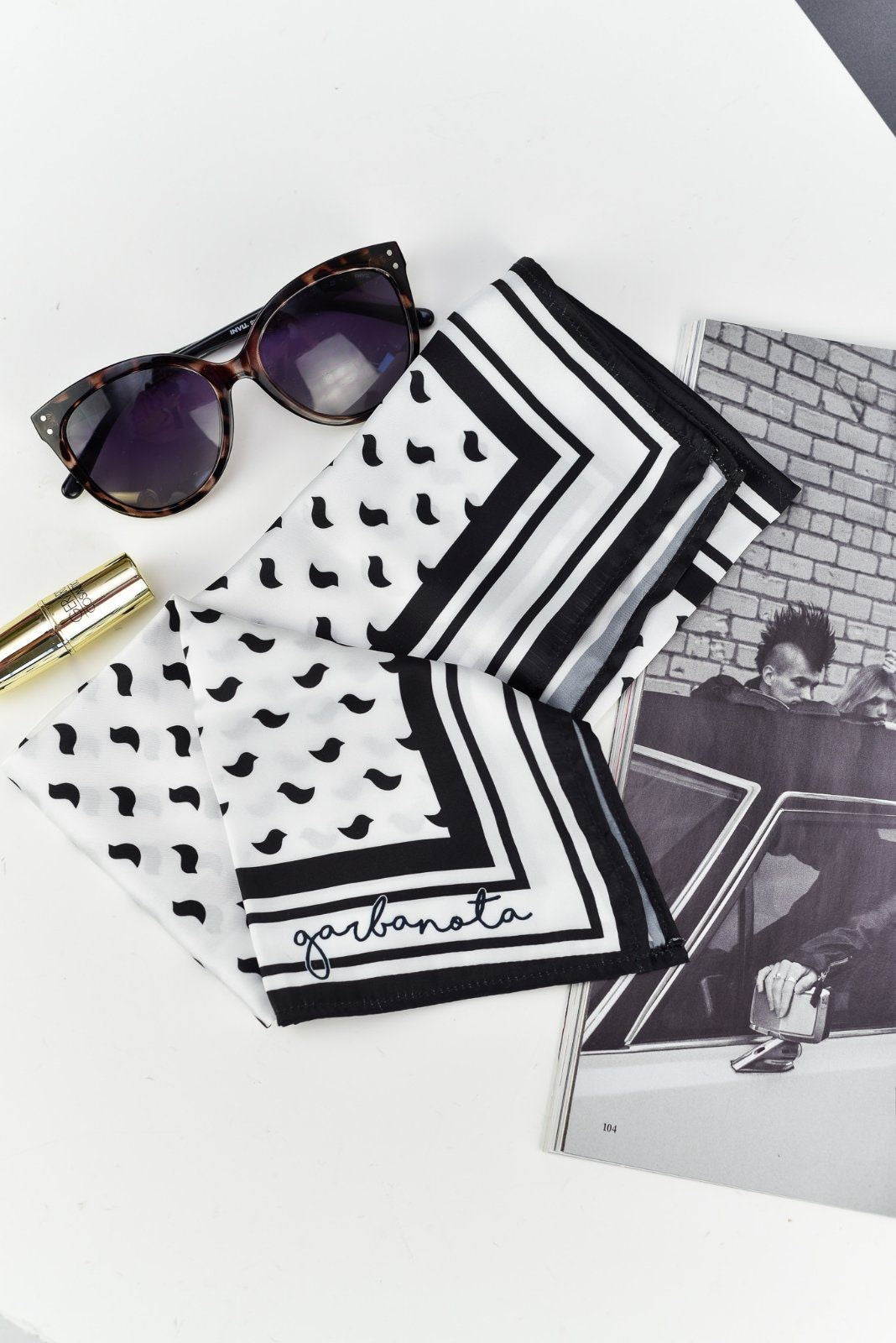 soft black bird scarf draped gently over a shoulder, showcasing its delicate pattern and comforting texture