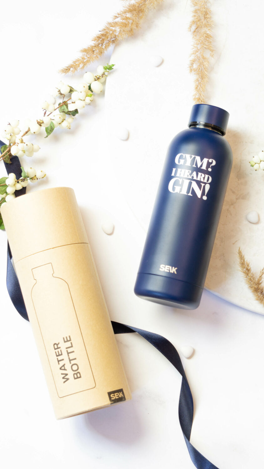 elegant dark blue seik thermos with witty gin slogan, held in hand against a sophisticated marble background