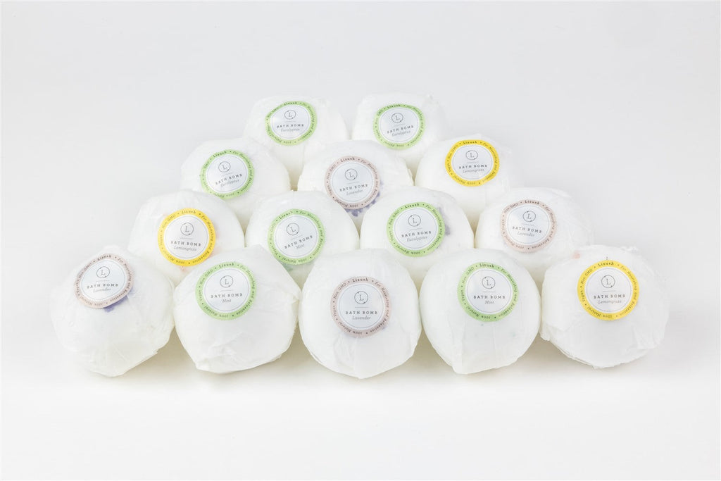 a playful spa gift set with a cute teddy bear peeking from a box of bath bombs and cocoa