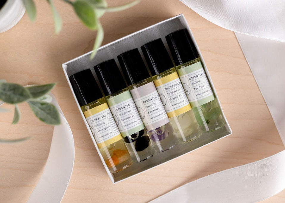 confident display of five crystal-infused essential oil roll-ons in a bold gift box