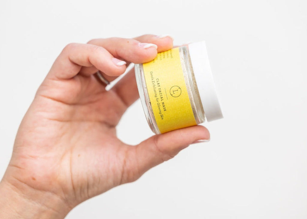 close-up of shea butter grapefruit scrub set on bathroom counter with natural ingredients