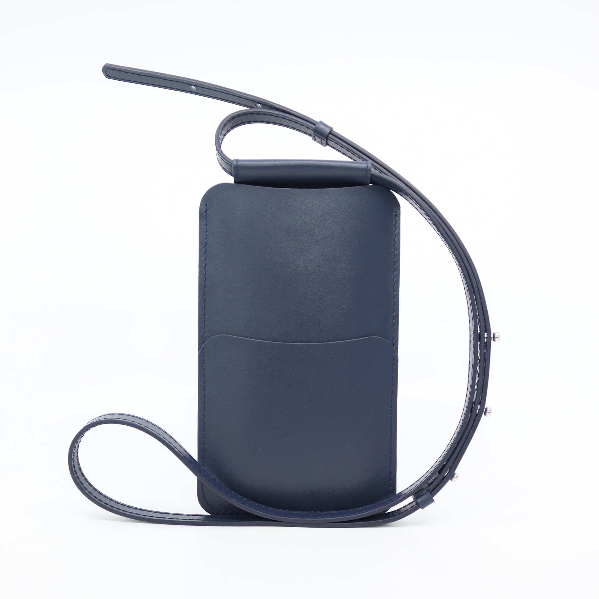bold navy leather phone bag with gold hardware on a model, showcasing its confident crossbody style