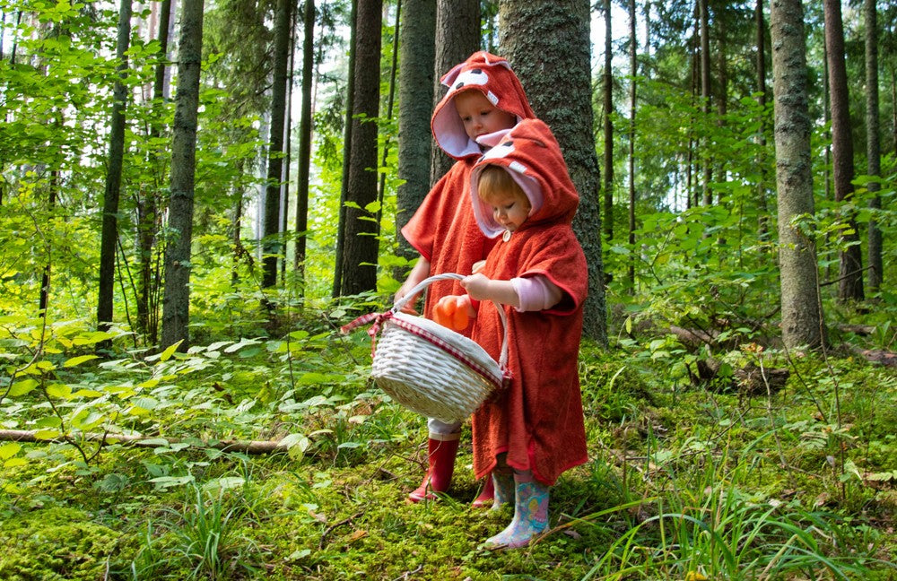 confident child in a bold fox poncho standing proud after a swim