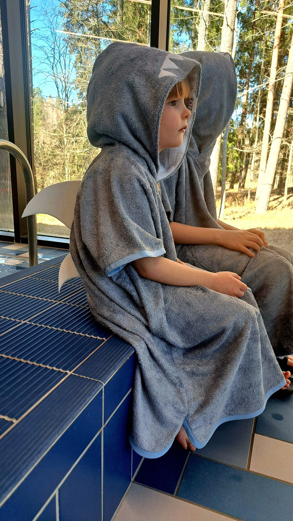 elegant handmade bamboo shark poncho for kids, shown in soft natural light, highlighting its refined terry texture and clean lines