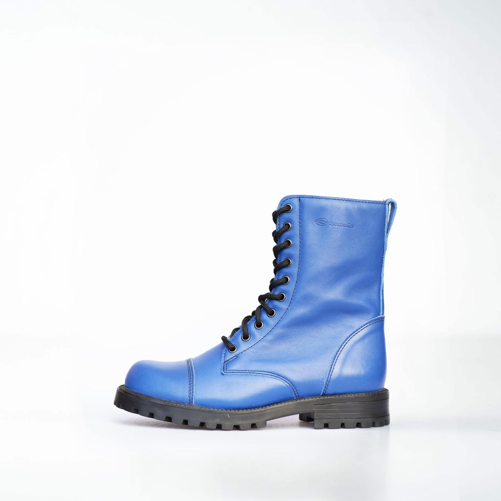 confident close-up of 511 blues punk boots in dramatic low light highlighting the rugged leather and tread