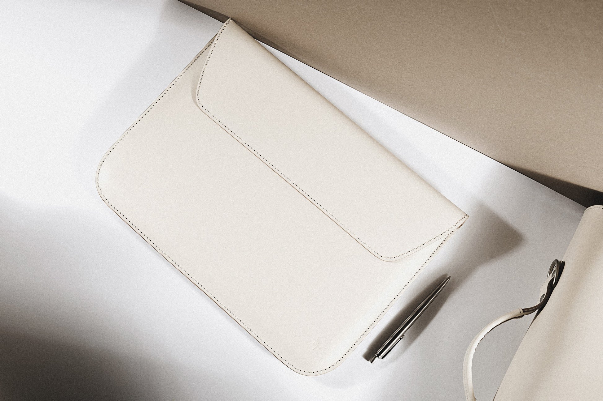 bold confident shot of a stylish slim note sack laptop case in natural leather