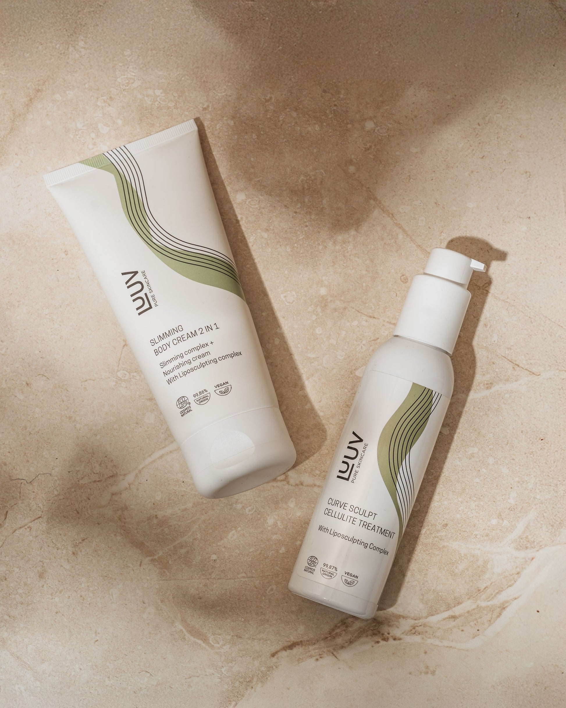 bold close-up of nourishing slimming body cream jar with fresh eucalyptus and shea butter