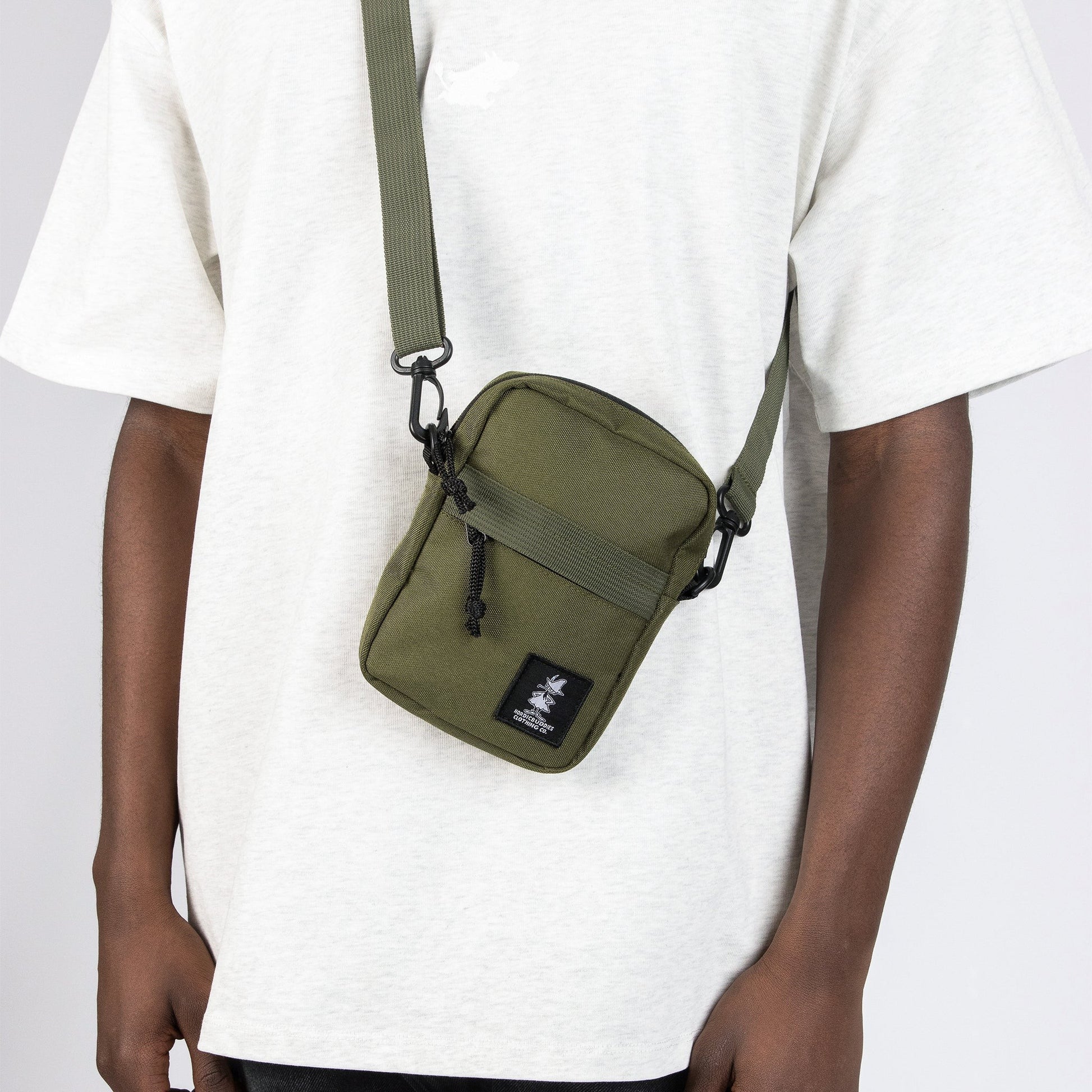 bold green snufkin crossbody bag for adventure, shown from a confident front angle