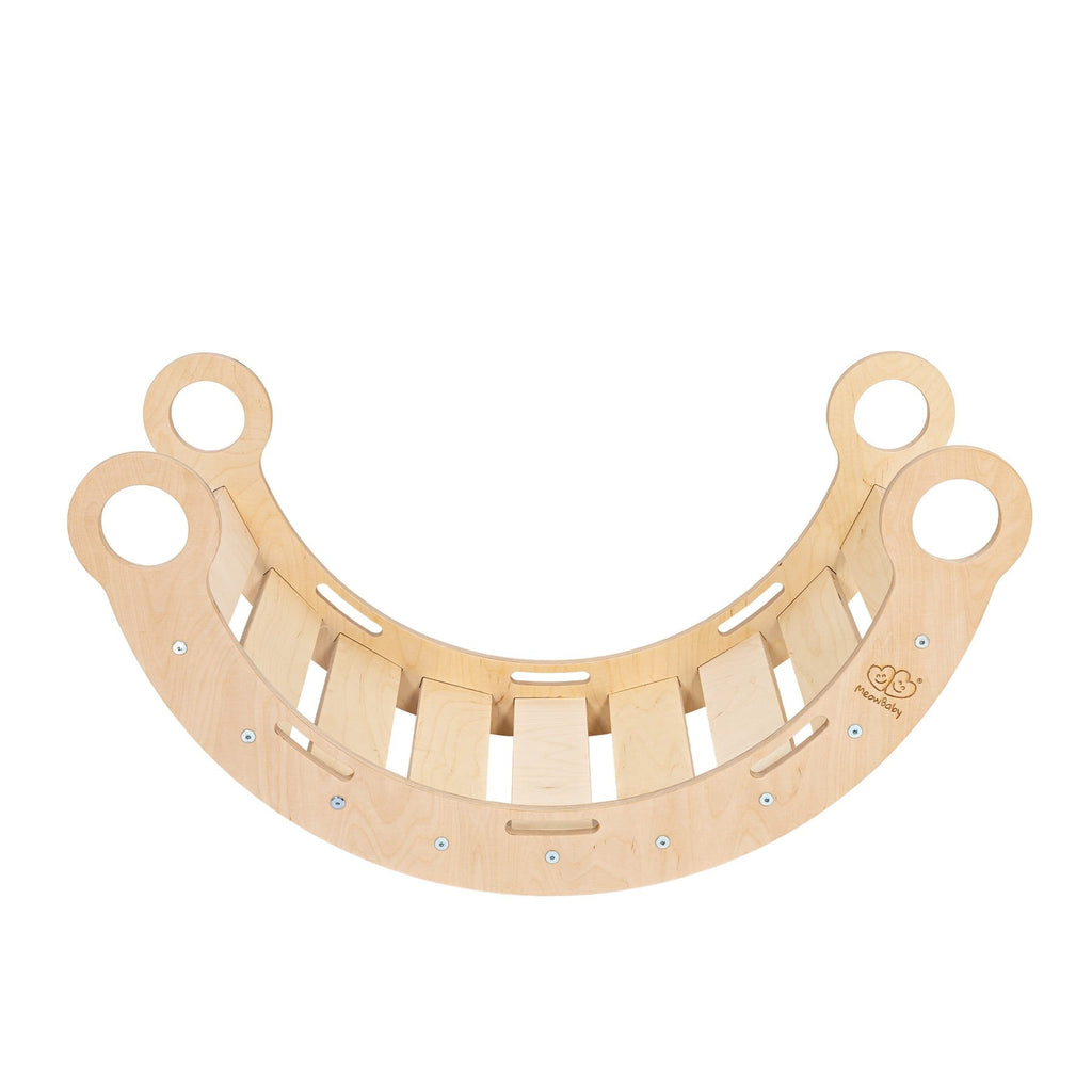 a child peeking through the snug rocker tunnel with a playful giggle