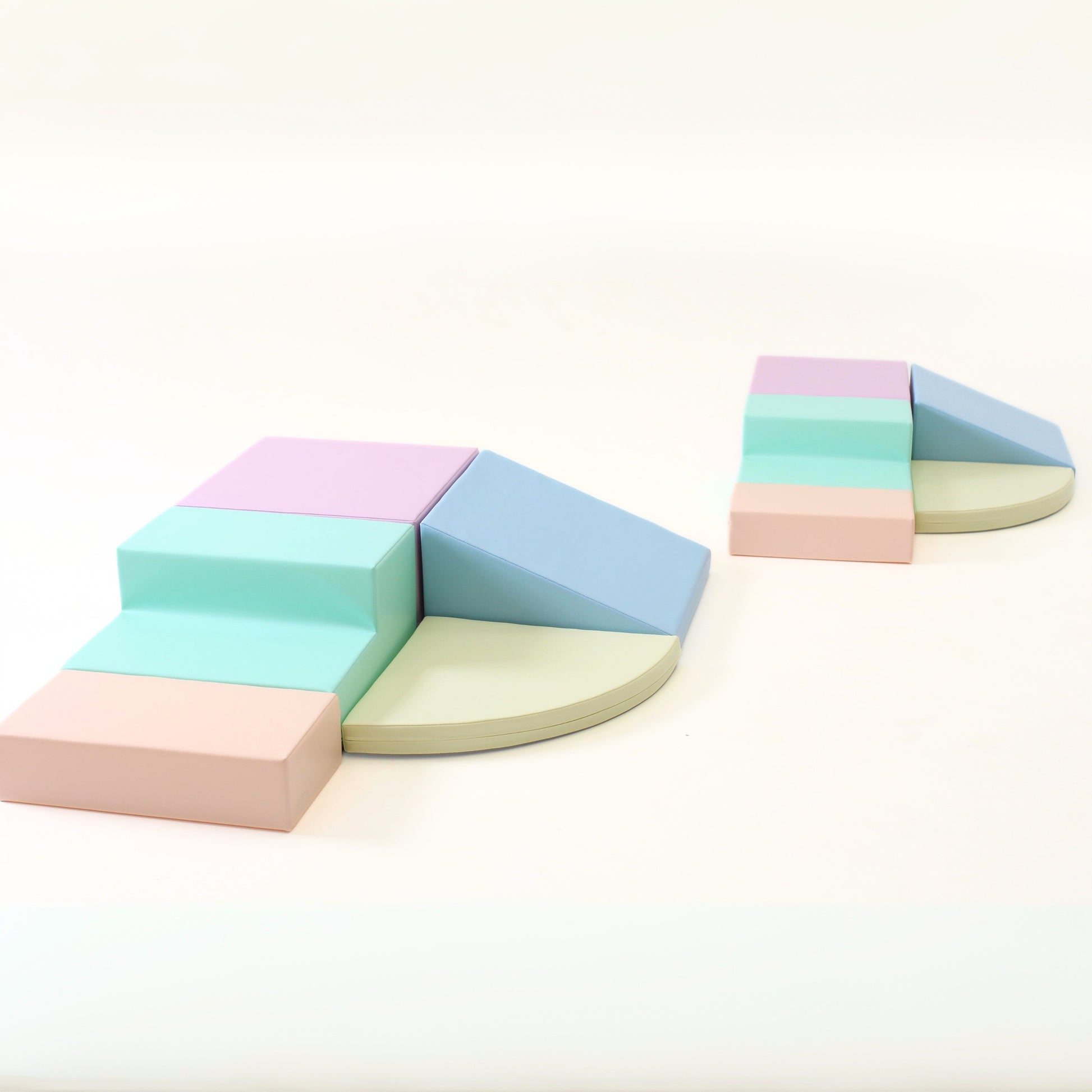 elegant light pastel foam corner climber in a minimalist, sunlit playroom setting