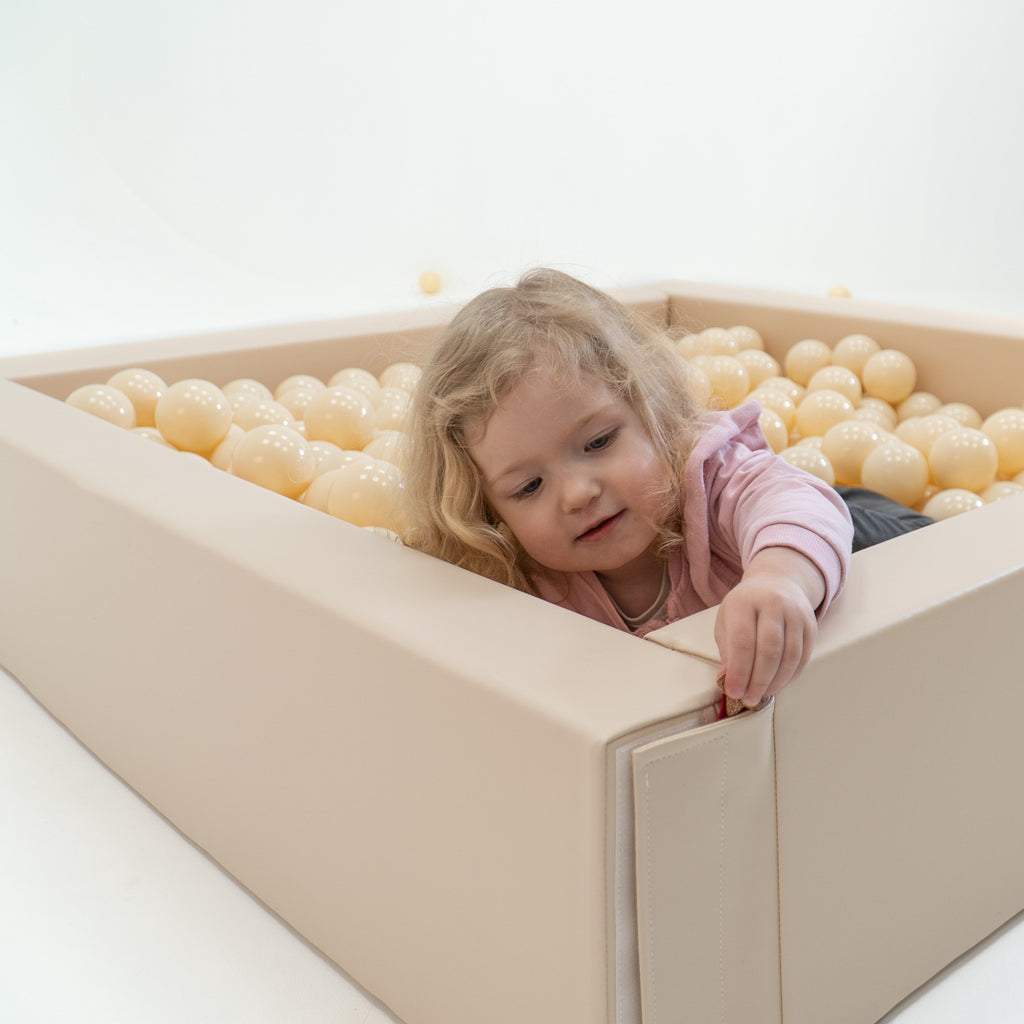 a gentle cascade of 500 soft beige ball pit balls, a calming sensory play space for a child