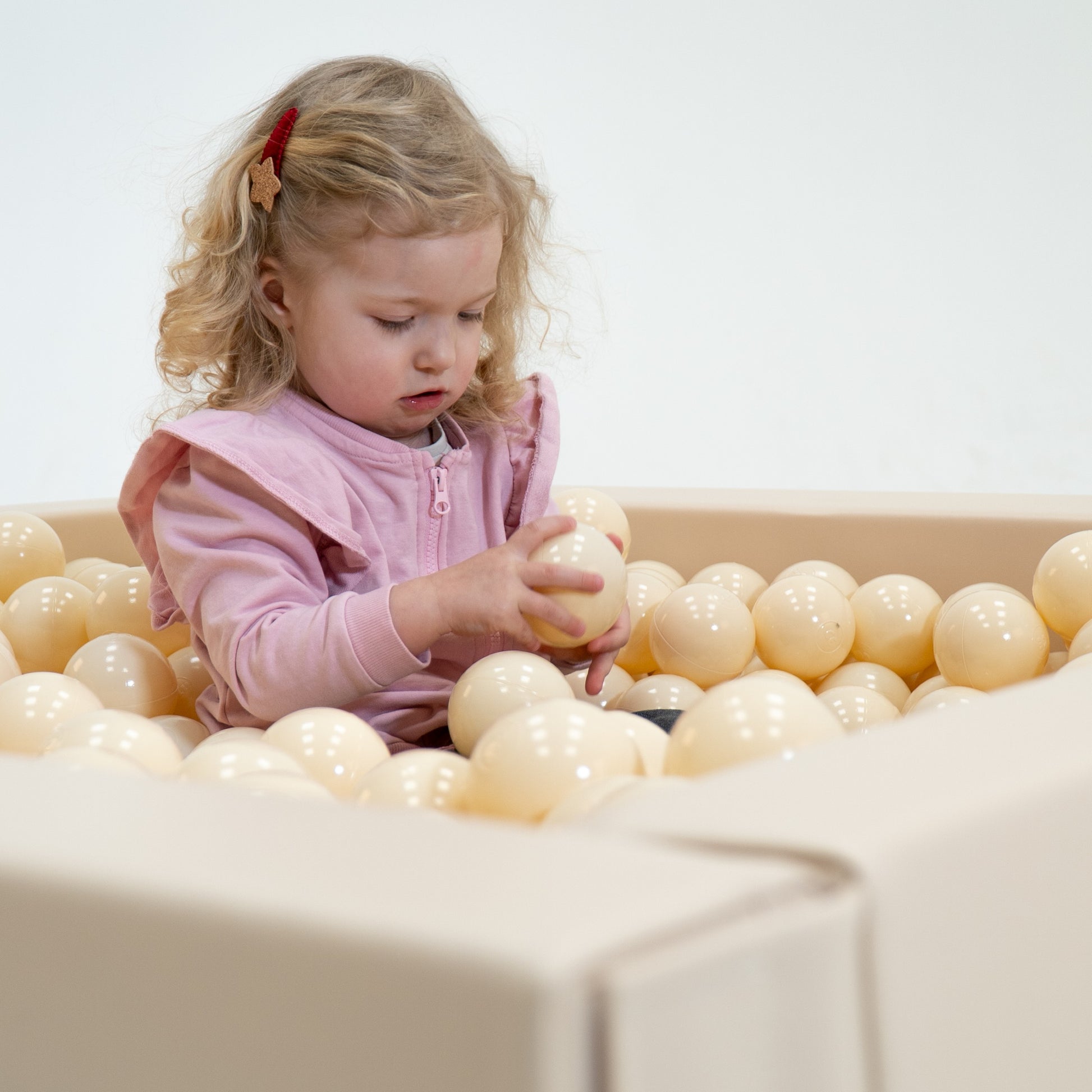 bold display of 500 beige ball pit balls in a modern kids furniture setting