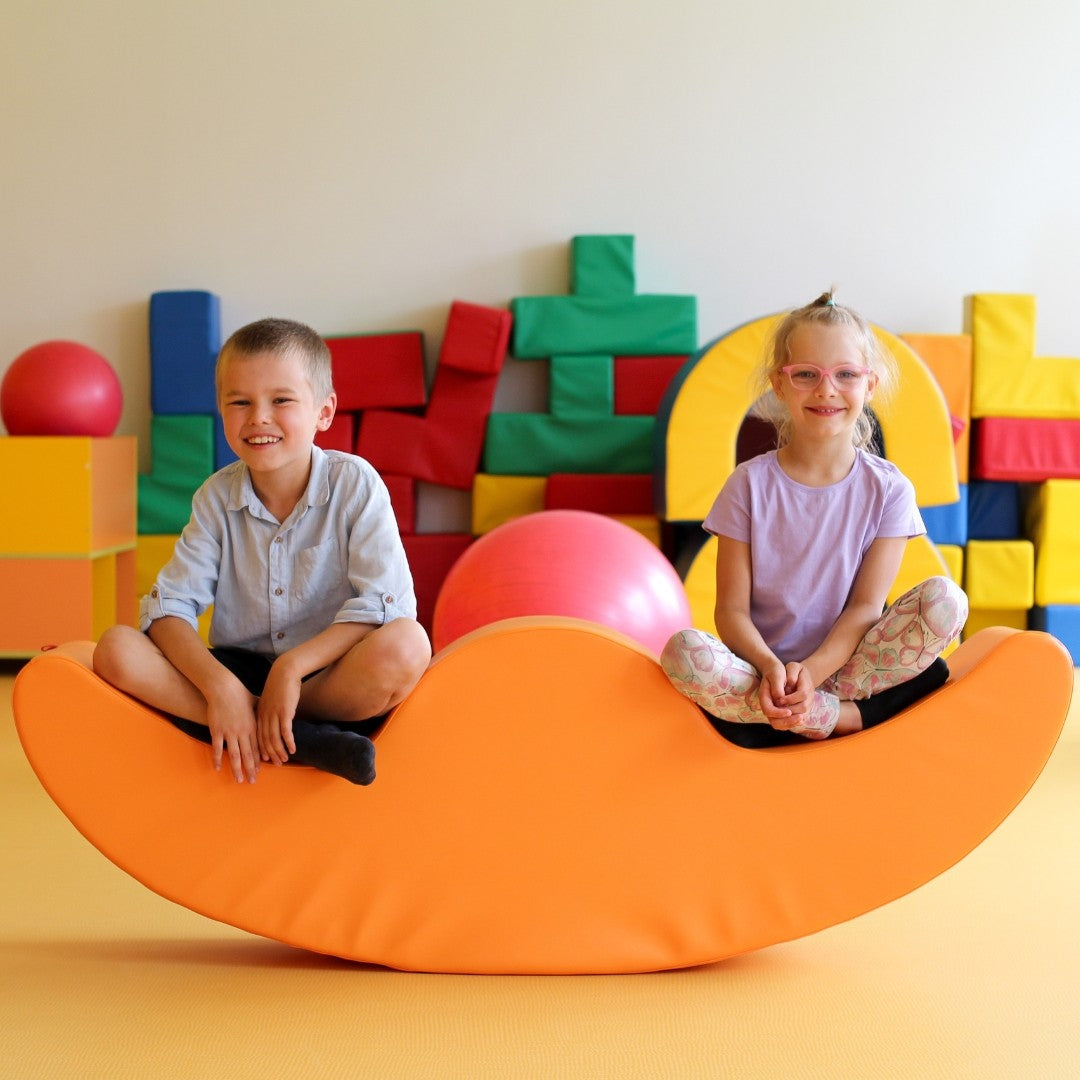 elegant white buddy double rocker in a bright, minimalist playroom setting