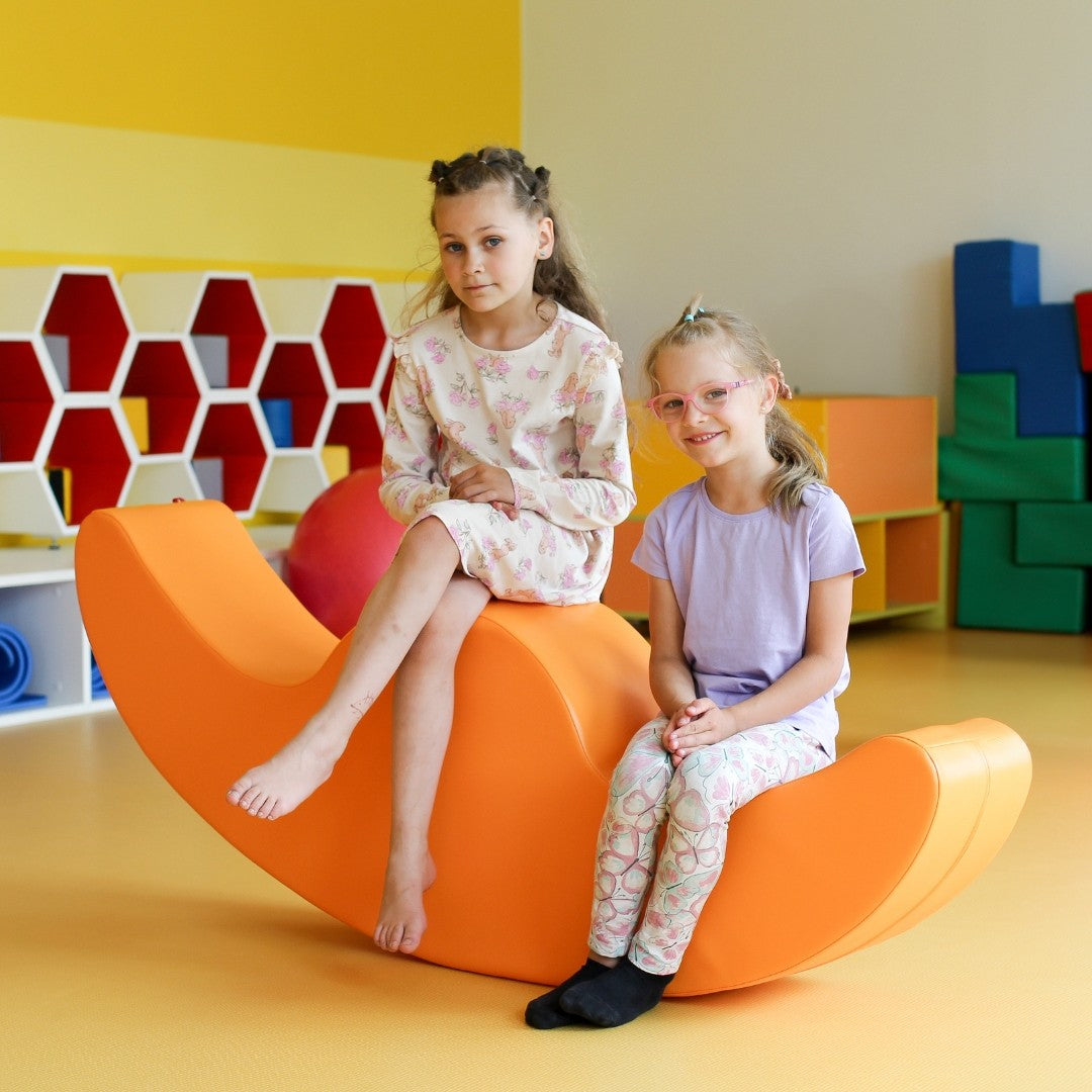 bold white buddy double rocker for two kids in a bright modern playroom
