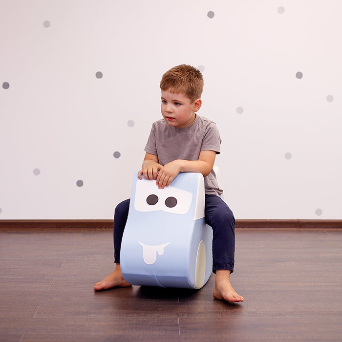 a soft light blue play car for toddlers, shown in a gentle nursery setting