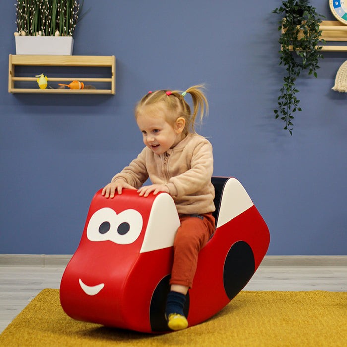 bold red iglu soft play ride-on car for kids on a vibrant adventure