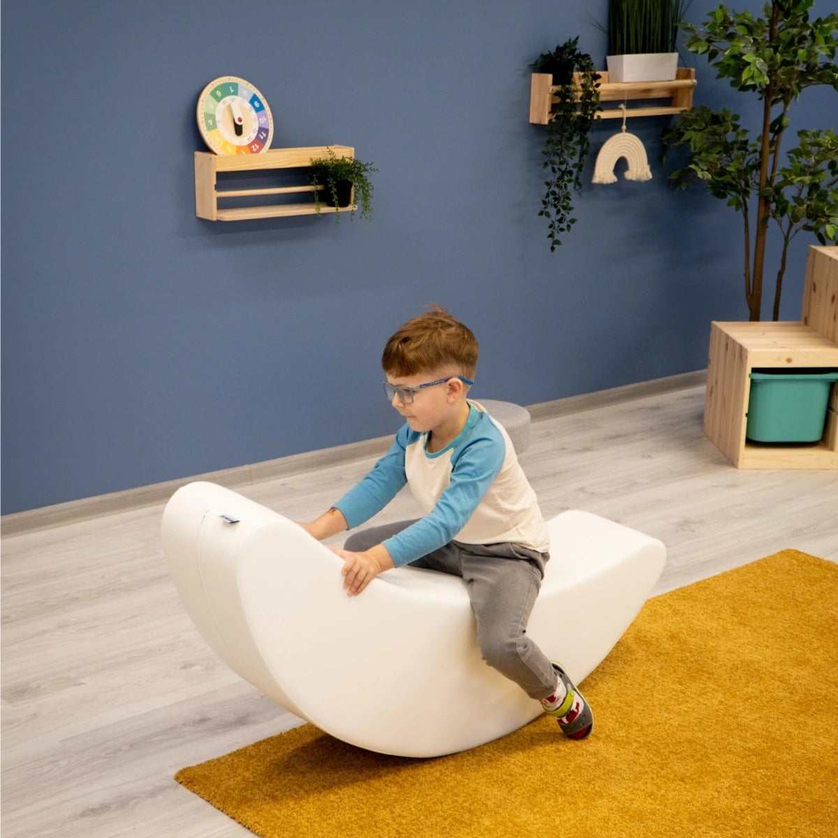 elegant white banana rocking toy for kids, promoting balance and creativity in a minimalist nursery