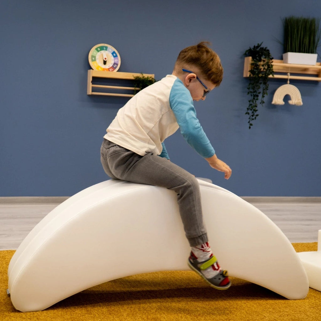 soft white banana rocking toy for toddlers, gently lit in a cozy nursery, promoting balance and playful giggles