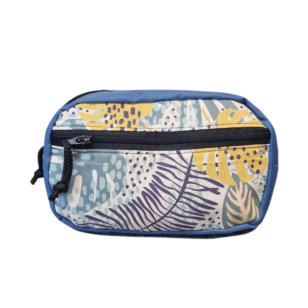 a playful tropics-themed waist bag worn crossbody, showing off its spacious compartments during a sunny day out