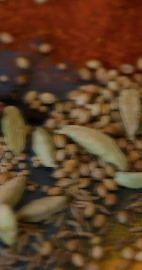 temple of sensus perfume bottle on a dark wood table with warm golden backlighting