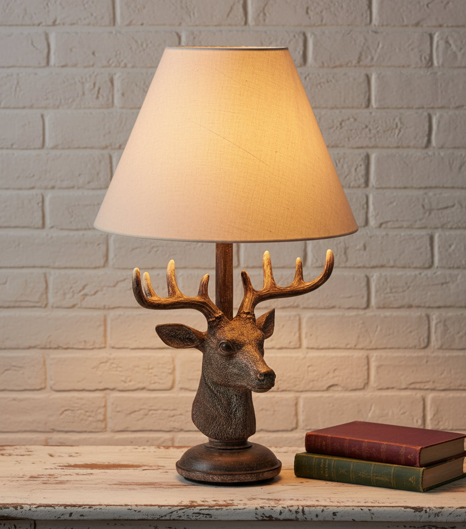 Decorative table lamp with deer head design on a reflective surface from brixbailey.com